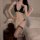 Woman modeling sexy lace lingerie set with pearl-embellished thong and bralette, featuring no-remove design and busty illusio...