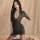 Woman wearing black lace lingerie set with short sleeves, deep v-neck, and sheer stockings; seductive sleepwear or nightclub ...