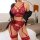 Woman wearing red lace lingerie set with sheer bra, panties, garter belt, and stockings; black jacket draped over shoulders.