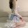 Woman wearing a sexy lace maid costume set with blue gingham and white floral details, japanese style role play outfit.