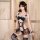 Woman modeling a black lace maid costume with sheer mesh tutu dress and seductive lingerie details.