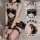 Woman wearing black lace maid costume with sheer mesh tutu, corset bra, and fishnet stockings.