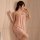 Woman wearing a sexy lace mesh backless nightgown, a seductive sheer sleep dress and intimate lingerie set for women.