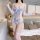 Woman wearing sheer floral embroidered bodysuit with lace mesh, elegant lingerie set for bedroom, featuring delicate straps a...
