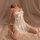Woman wearing white lace mesh sleepwear set with bow detail, sheer nightgown and matching bralette for plus size.