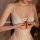 Woman wearing a white lace open-crotch bodysuit with delicate floral patterns and front clasp detail.