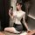 Woman in sexy lace secretary costume set with white blouse and black skirt, posing seductively in a mirror selfie.
