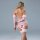 Woman wearing pink lace lingerie set with sheer sleeves and fishnet stockings, back view.