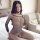 Woman wearing sexy lace see-through lingerie set with open-crotch bodysuit and butt-lifting design, posing on bed.