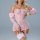 Woman wearing pink lace see-through lingerie set with embroidered details and matching garters.