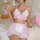 Woman wearing pink lace see-through maid costume with bows, erotic lingerie set for women, cross-border fashion.