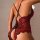 Woman wearing red and black lace bodysuit with sheer mesh, floral embroidery, and garter belt straps. elegant european-style ...