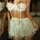 Sexy white lace chemise set with sheer push-up bra and matching thong, featuring delicate floral patterns and adjustable stra...
