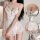 Woman wearing a white lace-trimmed sheer sleep dress with delicate straps and flirty hem, highlighting its sweet yet alluring...