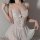 Woman wearing a sexy lace sheer sleep dress, sweet and alluring loungewear set with delicate floral details.