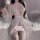 Woman in white lace sheer sleepwear set with open-crotch design, holding a rose — provocative uniform-style bodysuit for wome...