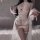 Woman modeling white lace sheer bodysuit with open-crotch design and flowing sleeves, part of the sexy lace sheer sleepwear s...