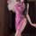 Woman wearing purple lace cheongsam sleepwear with high slit, holding feather fan.