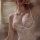 Woman wearing white lace sleep dress with push-up wire-free cami, body-conscious fit, and elegant trim for small bust.