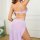 Woman wearing lavender lace sleepwear set with sheer mesh camisole and matching briefs, featuring elegant back straps.
