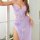 Woman wearing purple lace sleepwear set with sheer mesh camisole and matching briefs, elegant lounge lingerie.
