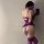 Woman wearing purple lace sleepwear with sheer mesh, long gloves, and thigh-high stockings, showcasing a sexy lingerie set.