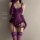 Purple lace lingerie set with sheer mesh, garter straps, and long gloves for a tempting, busty look.