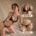 Woman modeling black lace thong bikini set with sheer open-crotch design, plus size seductive lingerie outfit.