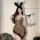 Woman wearing sexy leopard print lingerie set with bunny ears and heart wand for role play.