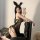 Woman wearing sexy leopard print lingerie set with bunny ears, posing on black chair for intimate moments.