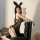 Woman in sexy leopard print lingerie set with bunny ears, posing seductively on a black leather chair for date night or role ...