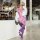 Woman modeling purple sheer mesh bodysuit with cut-outs, open-crotch design, and sleeveless style, paired with white fur stol...
