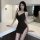 Sexy black bodycon slip dress featuring side slit, chain detail, and backless design, perfect for plus-size women.