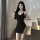 Sexy black bodycon slip dress featuring side slit, chain detail, and backless design, perfect for plus-size women.