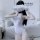 A woman poses with a cloud over her face, wearing a white one-piece bodysuit designed as office secretary attire. the outfit ...