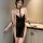 Woman wearing sheer black mesh lingerie set with gold chains and removable clips, styled as a seductive nurse costume for adu...