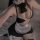 Woman wearing sexy maid lingerie set with halter neck bow, lace trim, and white apron.