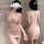 Woman modeling pink bodycon mini dress with ruched detail, featuring a halter neckline and open back design.