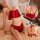 Woman modeling red sexy lingerie set with lace trim, featuring a flirty top and matching underwear for seductive sleepwear.