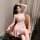 A woman elegantly poses wearing a sheer pink lace sleep dress with floral trim, featuring a low neckline and delicate spaghet...