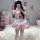 A person wearing a pink maid costume with ruffles and bows, taking a mirror selfie. the outfit features playful details suita...
