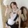 Woman modeling black and white lace maid costume with apron, headband, and wrist cuffs for seductive role play lingerie.