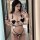 Woman in mirror wearing sexy maid costume: cute three-piece lingerie set with heart details & no-remove design for role play.