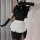 Sexy maid costume for women featuring a black top, white apron with ruffles, and long gloves, perfect for cosplay or nightclu...