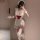 Woman in white lace maid costume with red bow, holding teacup, wearing thigh-highs and headpiece — sexy maid costume for wome...