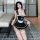 Sexy maid costume for women featuring a black and white dress with apron, headband, and stockings, perfect for seductive slee...