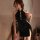Elegant black silk cheongsam dress with traditional buttons, perfect for evening wear or themed events.