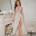 Elegant white lace slip dress with deep v-neckline and sheer fabric, featuring a high slit and delicate european-style design...