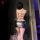 Woman wearing a sexy nightclub bodysuit, featuring a slim-fit backless design with tied straps and a low-cut neckline.