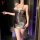 Woman modeling a slim-fit, backless silver bodysuit with low-cut neckline and tied straps for nightlife.